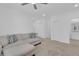Cozy living room featuring modern sofa, neutral colors, and carpeted floor at 2845 Pierr St, Davenport, FL 33837