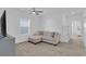 Comfortable living room area, with sofa, carpet, and a view to the hallway at 2845 Pierr St, Davenport, FL 33837