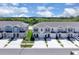 Street view of new townhomes featuring garages and well manicured landscaping at 2845 Pierr St, Davenport, FL 33837