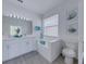 Bright bathroom with double vanity, soaking tub and neutral decor at 2908 Sunset Lakes Blvd, Kissimmee, FL 34747