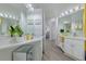 Modern bathroom featuring double sinks, quartz countertops, and bright vanity lighting at 2908 Sunset Lakes Blvd, Kissimmee, FL 34747