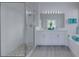Well-lit bathroom featuring double sinks, glass shower and soaking tub at 2908 Sunset Lakes Blvd, Kissimmee, FL 34747