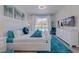 Comfortable primary bedroom with white furniture, blue accents, and plenty of natural light at 2908 Sunset Lakes Blvd, Kissimmee, FL 34747