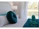 Close up of the bed in the primary bedroom showcasing blue donut pillow and swan towel at 2908 Sunset Lakes Blvd, Kissimmee, FL 34747
