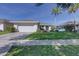 A well-kept single-story home with a two-car garage and green front lawn at 2908 Sunset Lakes Blvd, Kissimmee, FL 34747