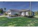 A lovely single-story home boasts a lush green lawn and well-maintained landscaping at 2908 Sunset Lakes Blvd, Kissimmee, FL 34747