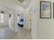 This hallway features decor and leads to multiple bedrooms, and a bathroom at 2908 Sunset Lakes Blvd, Kissimmee, FL 34747