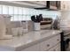Bright kitchen featuring white cabinets, quartz countertops, stainless steel appliances, and modern backsplash at 2908 Sunset Lakes Blvd, Kissimmee, FL 34747