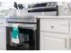 Stainless steel oven and white shaker cabinets with modern appliances and quartz countertops at 2908 Sunset Lakes Blvd, Kissimmee, FL 34747