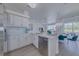 Bright kitchen featuring white cabinets, quartz countertops, stainless steel appliances, and adjacent dining area at 2908 Sunset Lakes Blvd, Kissimmee, FL 34747