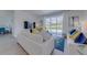 Spacious living room with stylish furnishings, a large window and television, perfect for relaxation at 2908 Sunset Lakes Blvd, Kissimmee, FL 34747