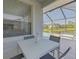 The outdoor patio with a table and chairs offers a view of the pond at 2908 Sunset Lakes Blvd, Kissimmee, FL 34747