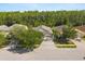 Overhead shot of a home with mature trees, manicured lawns, and a peaceful residential street at 3641 Bristol Cove Ln, St Cloud, FL 34772