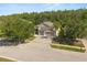 Overhead view of a well-landscaped home featuring mature trees and pristine lawn in a residential neighborhood at 3641 Bristol Cove Ln, St Cloud, FL 34772