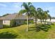 Spacious backyard with palm trees, white picket fence, and green lawn perfect for outdoor enjoyment at 3641 Bristol Cove Ln, St Cloud, FL 34772