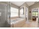Relaxing bathroom with soaking tub, separate shower, and neutral tile for a spa-like experience at 3641 Bristol Cove Ln, St Cloud, FL 34772