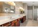 Elegant bathroom featuring double sinks, wood-look tile, and ample counter space at 3641 Bristol Cove Ln, St Cloud, FL 34772
