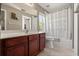 Bathroom with a dark wood vanity cabinet, and a shower/tub with a decorative shower curtain at 3641 Bristol Cove Ln, St Cloud, FL 34772