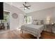 Charming bedroom with wood floors, vaulted ceilings, and a view to the bathroom at 3641 Bristol Cove Ln, St Cloud, FL 34772
