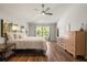 Bright bedroom with wood floors, soft lighting, and large windows for a peaceful retreat at 3641 Bristol Cove Ln, St Cloud, FL 34772
