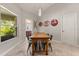 Bright dining room with a large window and unique decor, adjoining a view into a bathroom at 3641 Bristol Cove Ln, St Cloud, FL 34772