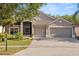 Charming home featuring a well-maintained lawn, mature trees, and a convenient two-car garage at 3641 Bristol Cove Ln, St Cloud, FL 34772