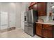 Stainless steel refrigerator complements granite countertops and cherry wood cabinetry at 3641 Bristol Cove Ln, St Cloud, FL 34772