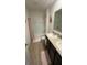 Neutral bathroom featuring a double vanity and bathtub with shower at 3673 Caspian St, Leesburg, FL 34748