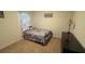 Cozy bedroom with floral decorations and patterned bedding, filled with natural light at 3673 Caspian St, Leesburg, FL 34748