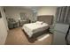 Bedroom featuring a bed, two nightstands, and curtains, offering a comfortable and relaxing space at 3673 Caspian St, Leesburg, FL 34748