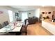 This living room, dining room and kitchen feature an open layout with neutral colored walls and tile flooring at 3673 Caspian St, Leesburg, FL 34748