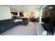 The home features an open floorplan with plush carpeting in the living room and an archway to the kitchen and dining area at 3673 Caspian St, Leesburg, FL 34748