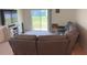 This spacious living room features plush carpeting, a sliding door, and provides access to the home's other living areas at 3673 Caspian St, Leesburg, FL 34748