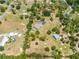 Aerial view of a home with a private pond, pool, long driveway, and expansive land at 3720 Edsel Ave, St Cloud, FL 34772