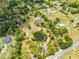 Scenic aerial view of a home with a tranquil pond surrounded by lush trees and greenery at 3720 Edsel Ave, St Cloud, FL 34772
