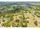 Expansive aerial view of a home with a private pond, lush greenery, and a long driveway at 3720 Edsel Ave, St Cloud, FL 34772