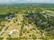 Wide aerial view features a home with a private pond, expansive land, and winding driveway at 3720 Edsel Ave, St Cloud, FL 34772