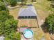 Aerial back view showcasing a home with a screened-in porch, above-ground pool, and green backyard at 3720 Edsel Ave, St Cloud, FL 34772