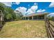 A spacious backyard featuring green lawn, shed, fencing and plenty of room for outdoor activities at 3720 Edsel Ave, St Cloud, FL 34772