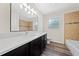 Bathroom vanity features a quartz countertop, black cabinets, and a large mirror at 3720 Edsel Ave, St Cloud, FL 34772