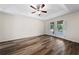 Bedroom featuring wood-look flooring, tray ceilings, and doors to an outdoor area at 3720 Edsel Ave, St Cloud, FL 34772