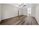 Spacious bedroom with tray ceiling, ceiling fan, and wood-look flooring at 3720 Edsel Ave, St Cloud, FL 34772