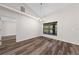 Dining area featuring wood-look flooring, a modern chandelier, and a large window at 3720 Edsel Ave, St Cloud, FL 34772