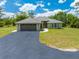 Attractive single-story home with a two-car garage, enhanced by a well-manicured lawn and blue skies overhead at 3720 Edsel Ave, St Cloud, FL 34772