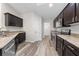 Modern kitchen featuring dark cabinets, stainless steel appliances, and granite countertops at 3720 Edsel Ave, St Cloud, FL 34772