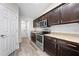 Well-lit kitchen with stainless steel appliances, granite countertops, and dark wood cabinetry at 3720 Edsel Ave, St Cloud, FL 34772