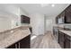 Kitchen boasts granite countertops, stainless steel appliances, and dark wood cabinetry at 3720 Edsel Ave, St Cloud, FL 34772