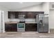 Modern kitchen with dark cabinets, stainless steel appliances, and granite countertops at 3720 Edsel Ave, St Cloud, FL 34772