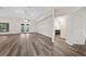 Spacious living room with laminate flooring, vaulted ceiling, ceiling fan, and access to the back patio at 3720 Edsel Ave, St Cloud, FL 34772