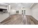 Open-concept living room with hardwood floors, high ceilings, a ceiling fan, and access to a kitchen at 3720 Edsel Ave, St Cloud, FL 34772